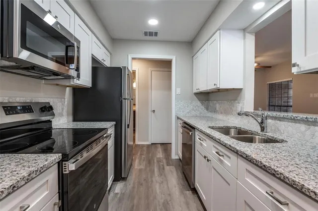 a kitchen with a sink stove and refrigerator
