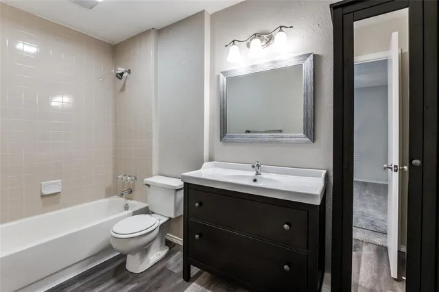 a bathroom with a toilet a sink and bathtub