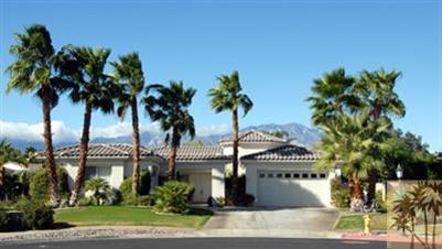 40 Abby Road Rancho Mirage, CA 92270 - Photo 1 of 6 a front view of multi story residential apartment building with yard and sign board