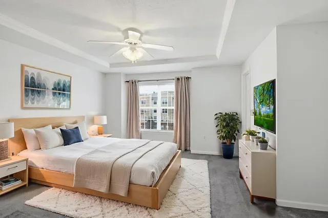 a bedroom with a large bed and a chandelier