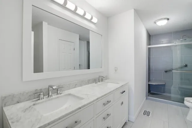 a bathroom with a granite countertop sink mirror and double