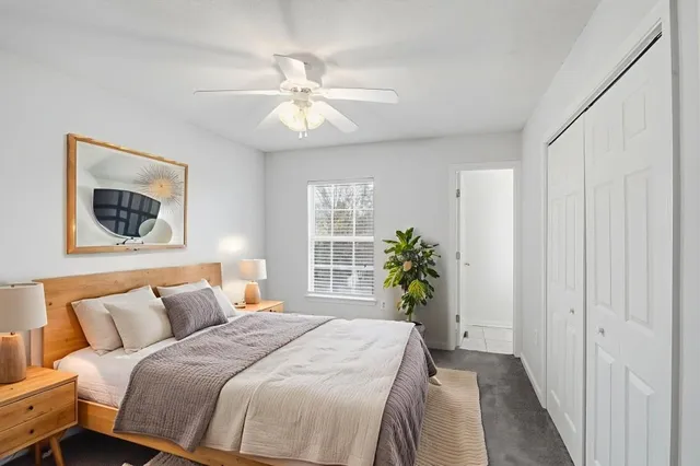a bedroom with bed and a chandelier
