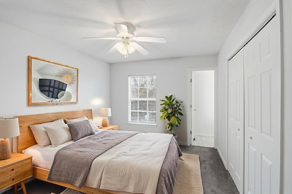 1732 Pryor Road Southwest, Unit 803 Atlanta, GA 30315 - Photo 19 of 26 a bedroom with bed and a chandelier