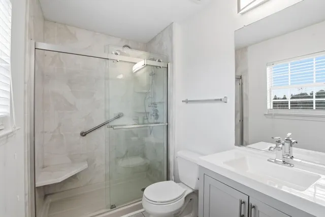 a bathroom with a sink toilet and shower