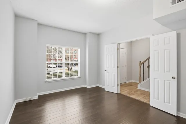a view of a livingroom with wooden floor and a window