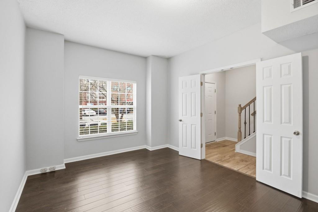 1732 Pryor Road Southwest, Unit 803 Atlanta, GA 30315 - Photo 21 of 26 a view of a livingroom with wooden floor and a window