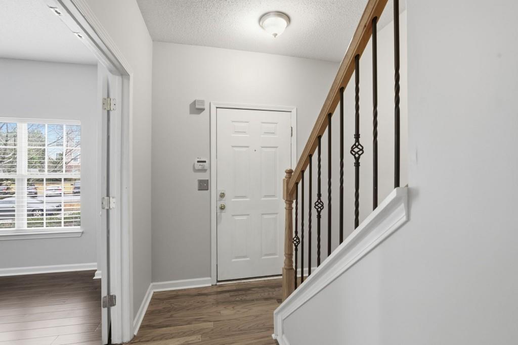 1732 Pryor Road Southwest, Unit 803 Atlanta, GA 30315 - Photo 3 of 26 a view of a hallway with wooden floor and staircase
