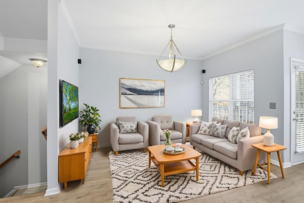 1732 Pryor Road Southwest, Unit 803 Atlanta, GA 30315 - Photo 6 of 26 a living room with furniture and a chandelier