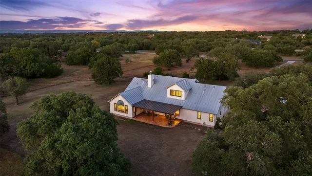 an aerial view of a house with a yard