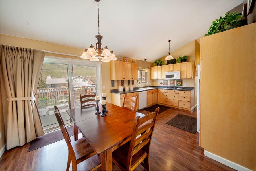 53 Big Elk Road Dillon, CO 80435 - Photo 15 of 33 a dining room with stainless steel appliances a dining table chairs and a chandelier
