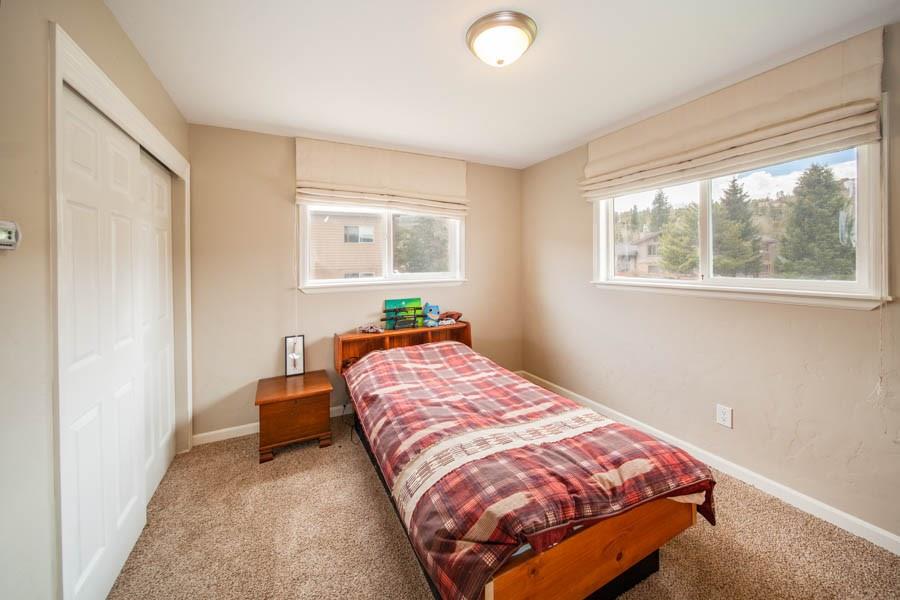 53 Big Elk Road Dillon, CO 80435 - Photo 20 of 33 a bed sitting in a bedroom next to a window