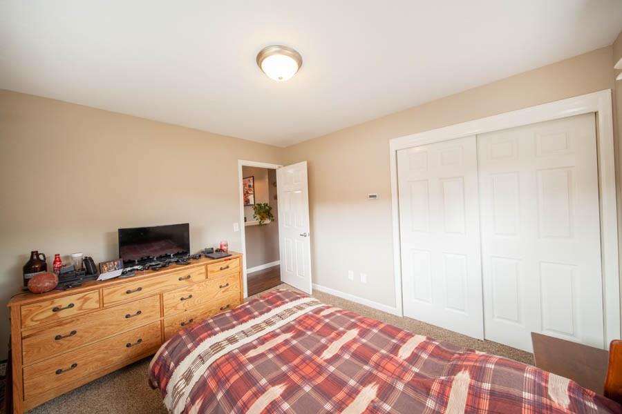 53 Big Elk Road Dillon, CO 80435 - Photo 21 of 33 a bedroom with a bed and flat tv screen on the dresser
