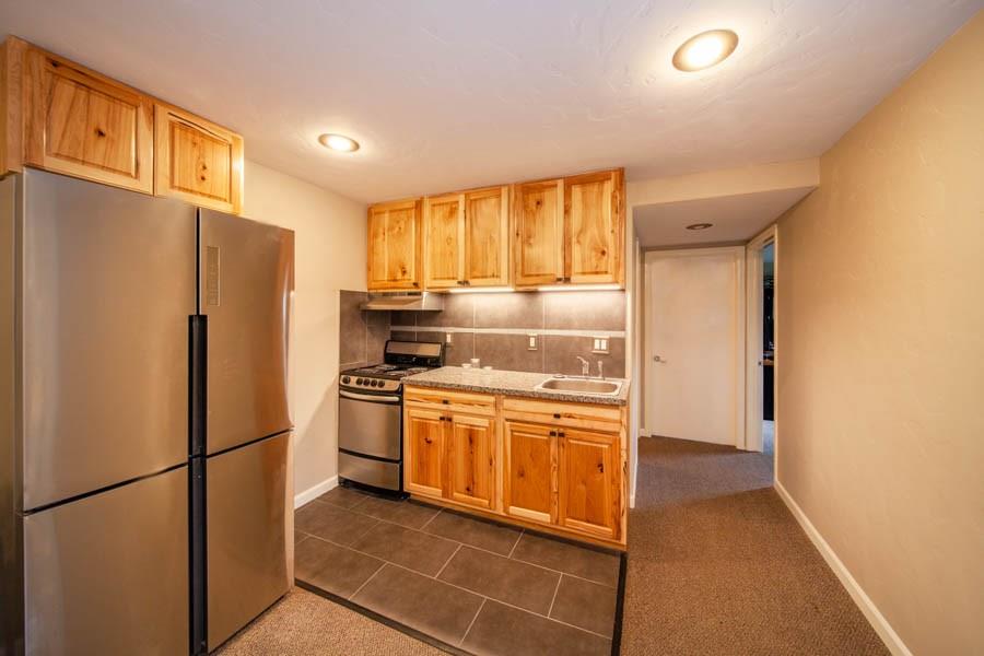 53 Big Elk Road Dillon, CO 80435 - Photo 25 of 33 a kitchen with stainless steel appliances granite countertop a refrigerator a sink and a stove