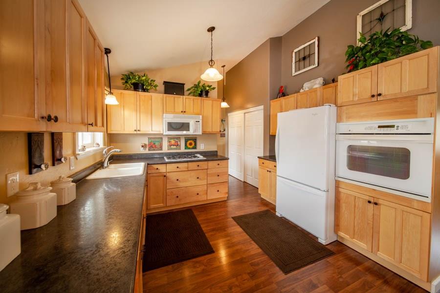 53 Big Elk Road Dillon, CO 80435 - Photo 28 of 33 a kitchen with stainless steel appliances granite countertop a refrigerator a stove and a cabinets with wooden floor
