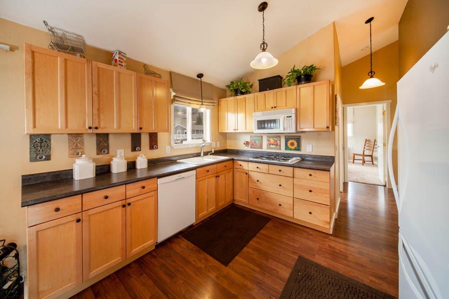 53 Big Elk Road Dillon, CO 80435 - Photo 29 of 33 a kitchen with stainless steel appliances kitchen island granite countertop a sink window and cabinets