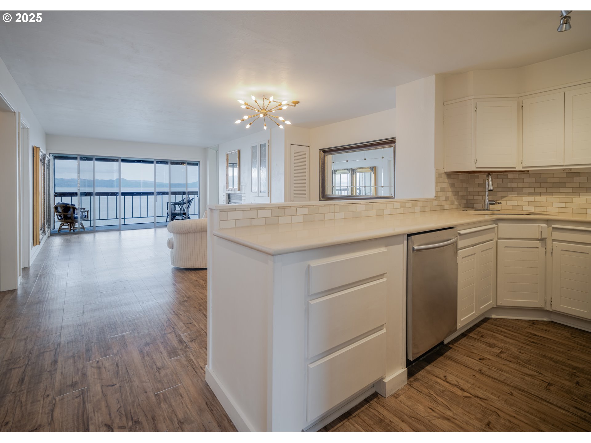 1 3rd Street, Unit 209 Astoria, OR 97103 - Photo 11 of 37 a kitchen with a sink cabinets and wooden floor