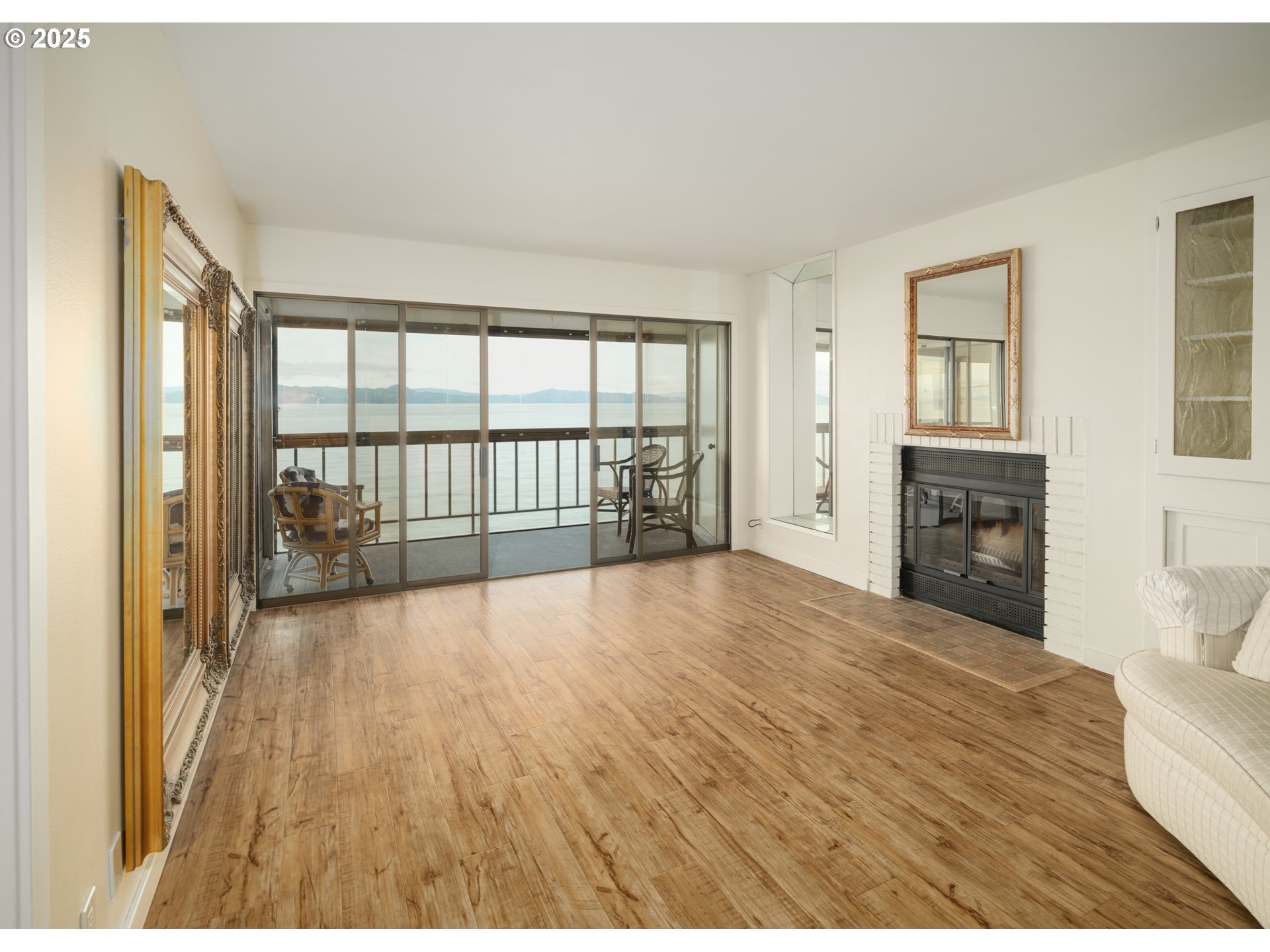 1 3rd Street, Unit 209 Astoria, OR 97103 - Photo 13 of 37 a view of empty room with wooden floor and fireplace