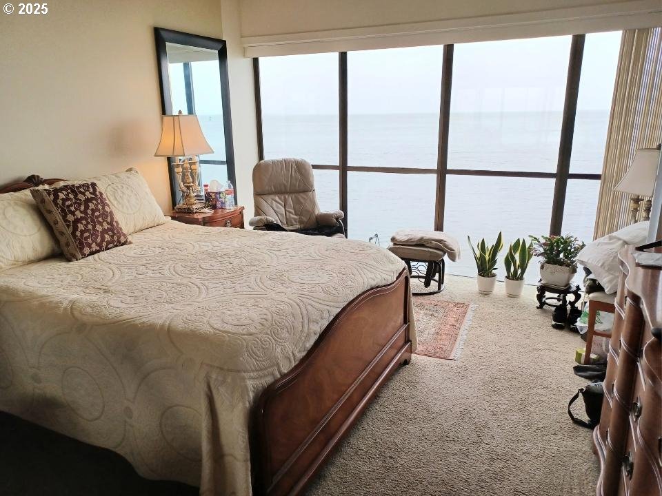 1 3rd Street, Unit 209 Astoria, OR 97103 - Photo 32 of 37 a bedroom with a bed and a large window