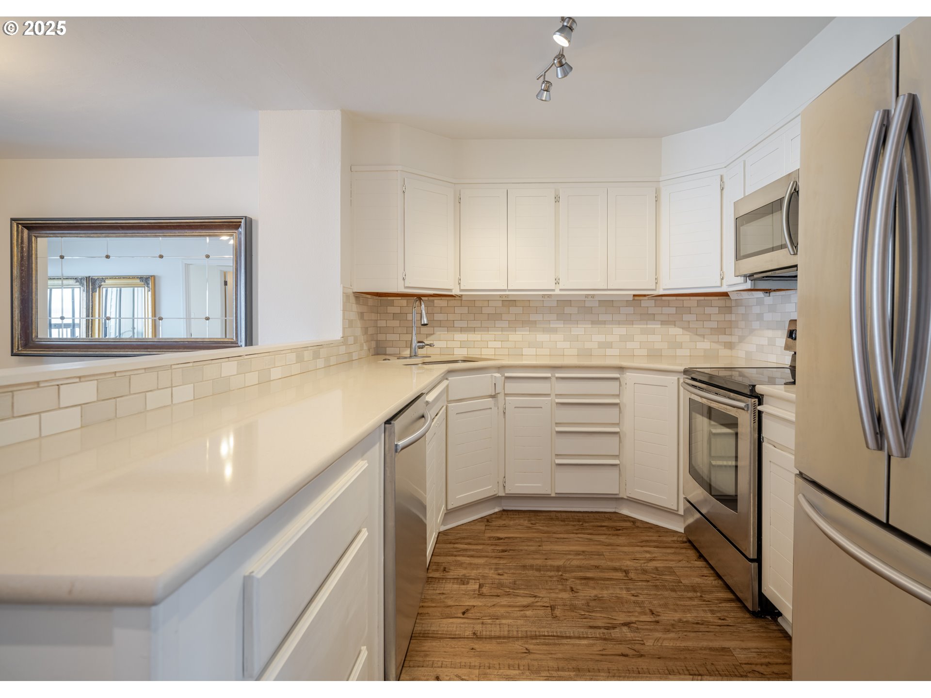 1 3rd Street, Unit 209 Astoria, OR 97103 - Photo 9 of 37 a kitchen with white cabinets and white appliances