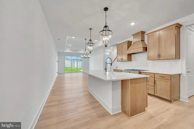 a large kitchen with kitchen island a sink stainless steel appliances and cabinets