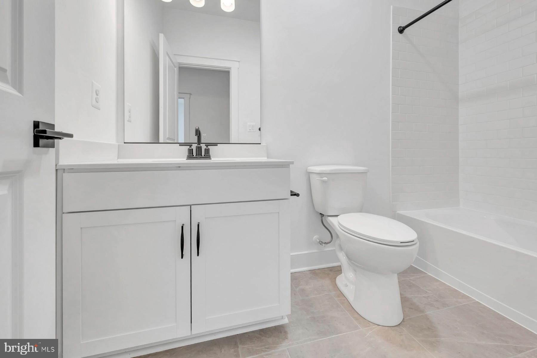 4803 Grandiflora Circle Perry Hall, MD 21128 - Photo 24 of 30 a bathroom with a toilet sink and mirror