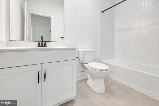 a bathroom with a toilet sink and a mirror