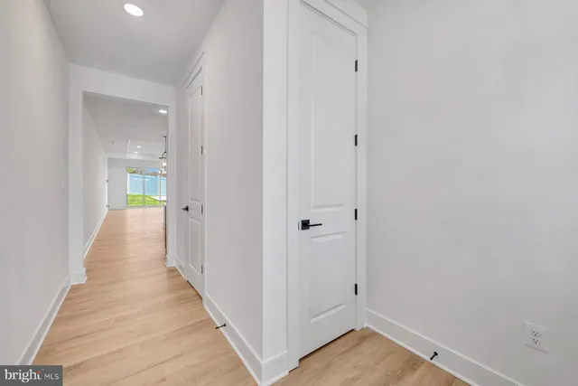 a view of a hallway with wooden floor