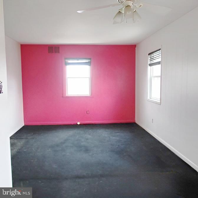 718 Mayo Road Glen Burnie, MD 21061 - Photo 44 of 48 Vibrant pink accent wall in a spacious room.