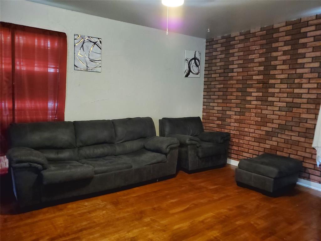 a living room with furniture and a wall