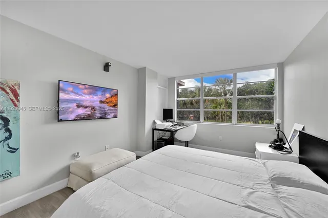 a bedroom with a bed and a flat screen tv