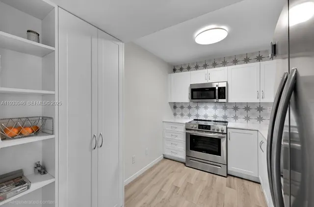 a kitchen with stainless steel appliances a stove a microwave and a refrigerator