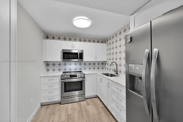 a kitchen with stainless steel appliances granite countertop a stove and a refrigerator