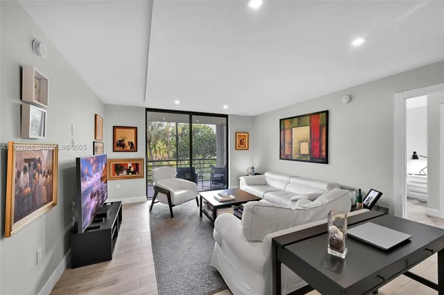 a living room with furniture and a floor to ceiling window