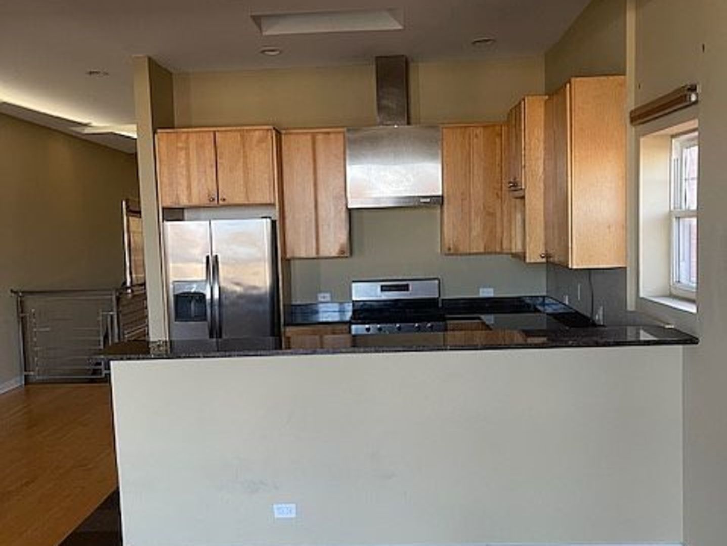 1625 North Halsted Street Chicago, IL 60614 - Photo 4 of 9 a kitchen with stainless steel appliances a sink and a refrigerator