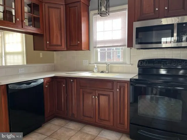 a kitchen with a sink stove and microwave