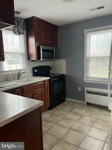 a kitchen with a cabinets and steel appliances