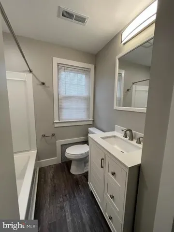 a bathroom with a sink a toilet and a mirror