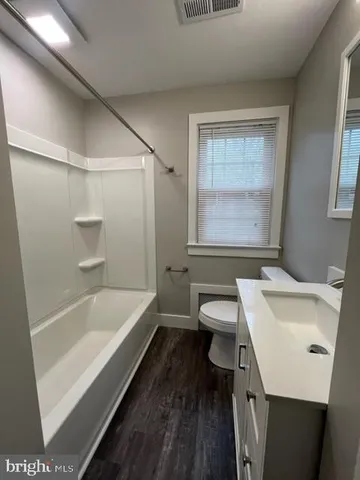 a bathroom with a sink a toilet and a bathtub