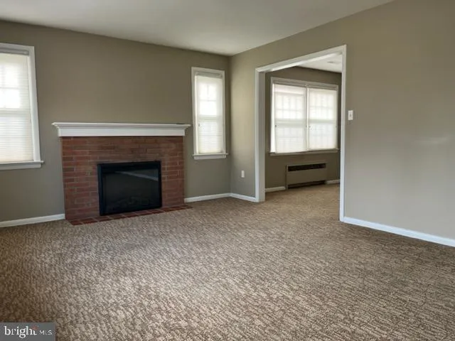 an empty room with furniture and a fireplace