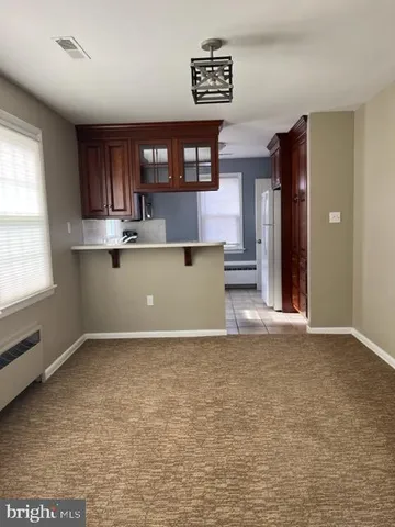 an empty room with window and stairs