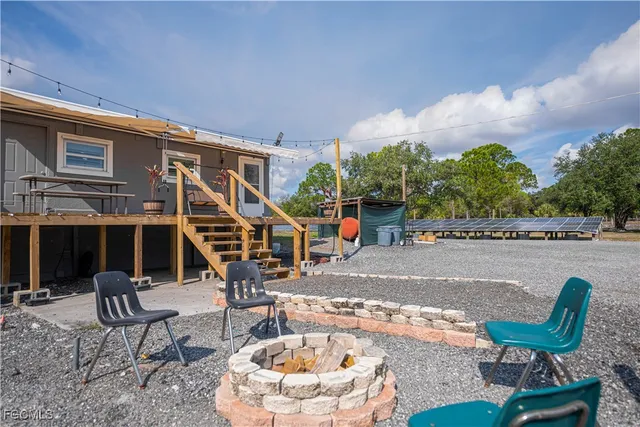 a swimming pool with outdoor seating and barbeque oven