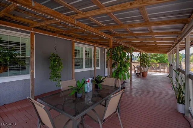a view of a porch with furniture and a potted plant