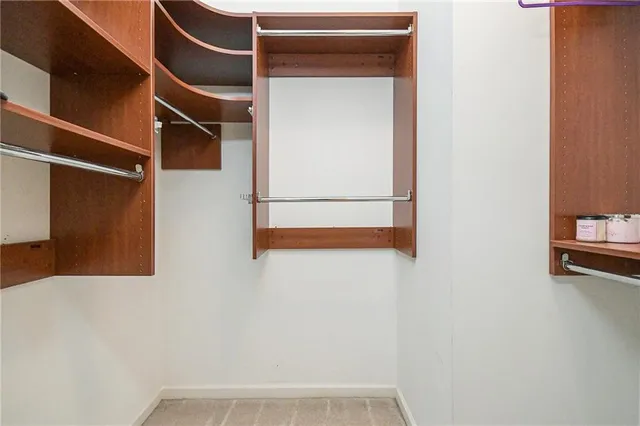 a bathroom with a granite countertop sink mirror and toilet