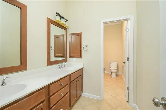 a white toilet sitting next to a bathroom sink