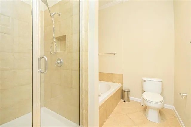 a bedroom with a balcony a bed and a potted plant