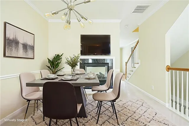 a dining room with furniture a flat screen tv and a window