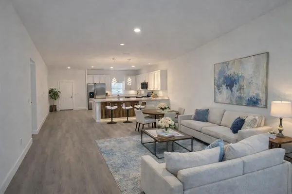a living room with furniture and kitchen view