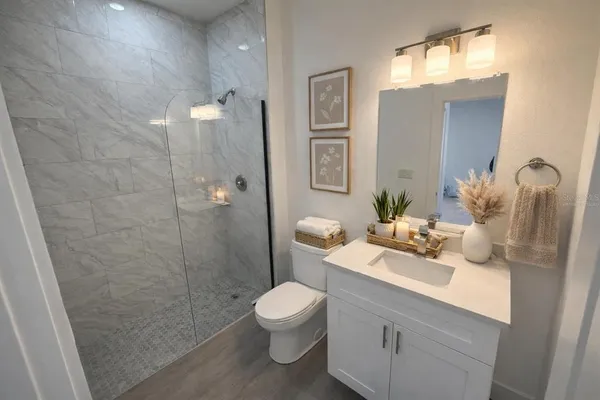 a bathroom with a sink toilet and shower