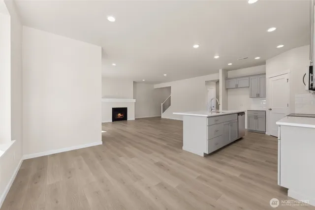 a view of kitchen with furniture and wooden floor
