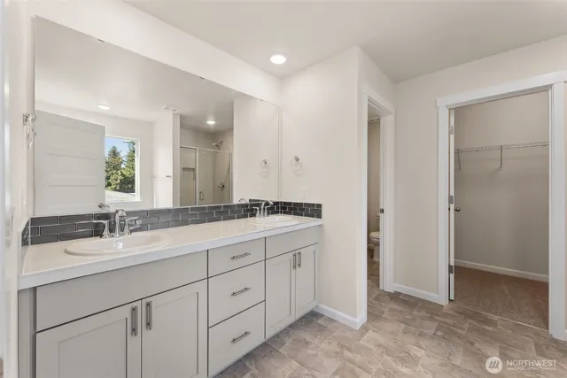 a bathroom with a double vanity sink and mirror